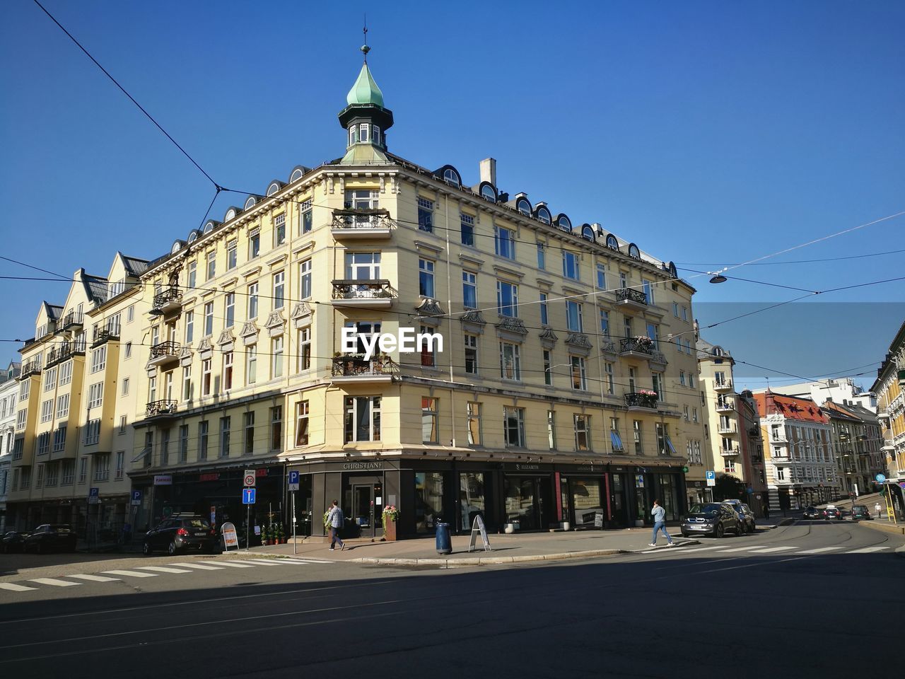 View of buildings against clear blue sky