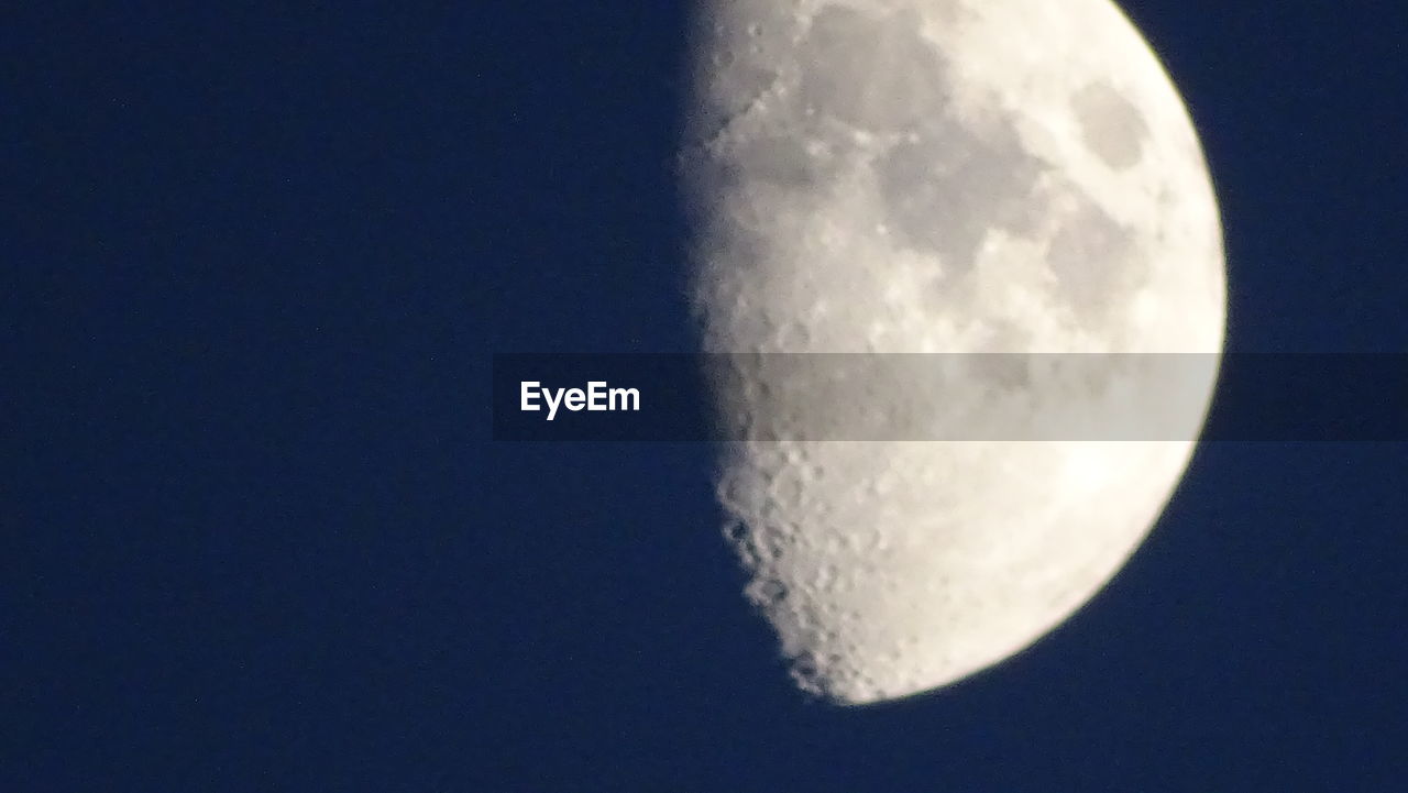 LOW ANGLE VIEW OF HALF MOON AGAINST SKY AT NIGHT