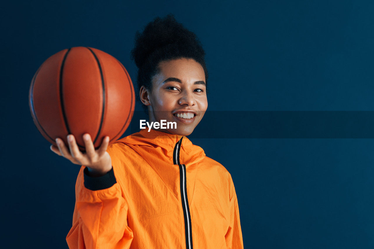 mid adult woman playing basketball