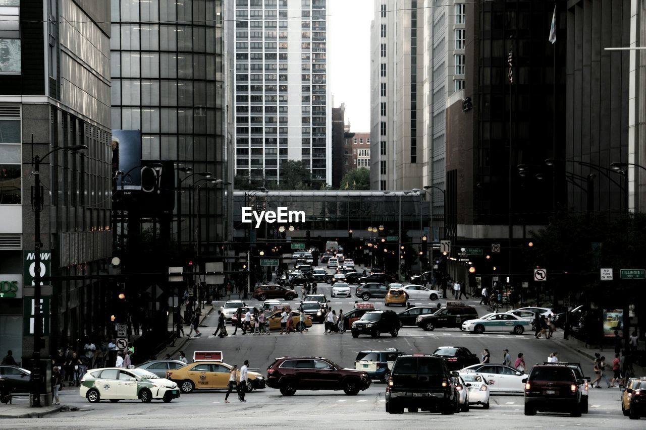 Cars on city street amidst buildings