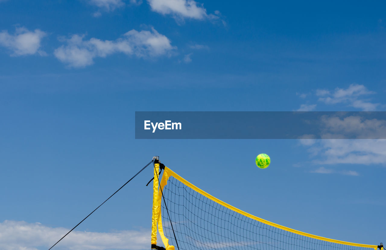 LOW ANGLE VIEW OF BASKETBALL BALL AGAINST SKY