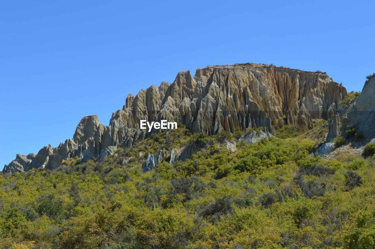 Scenic view of mountain against clear blue sky