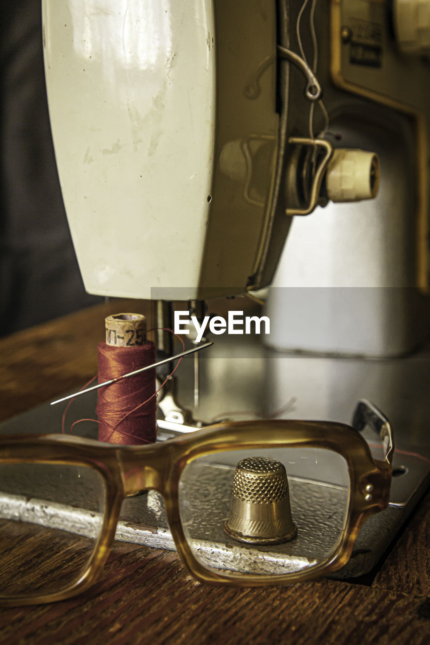 View of the thimble through glasses on the sewing machine table
