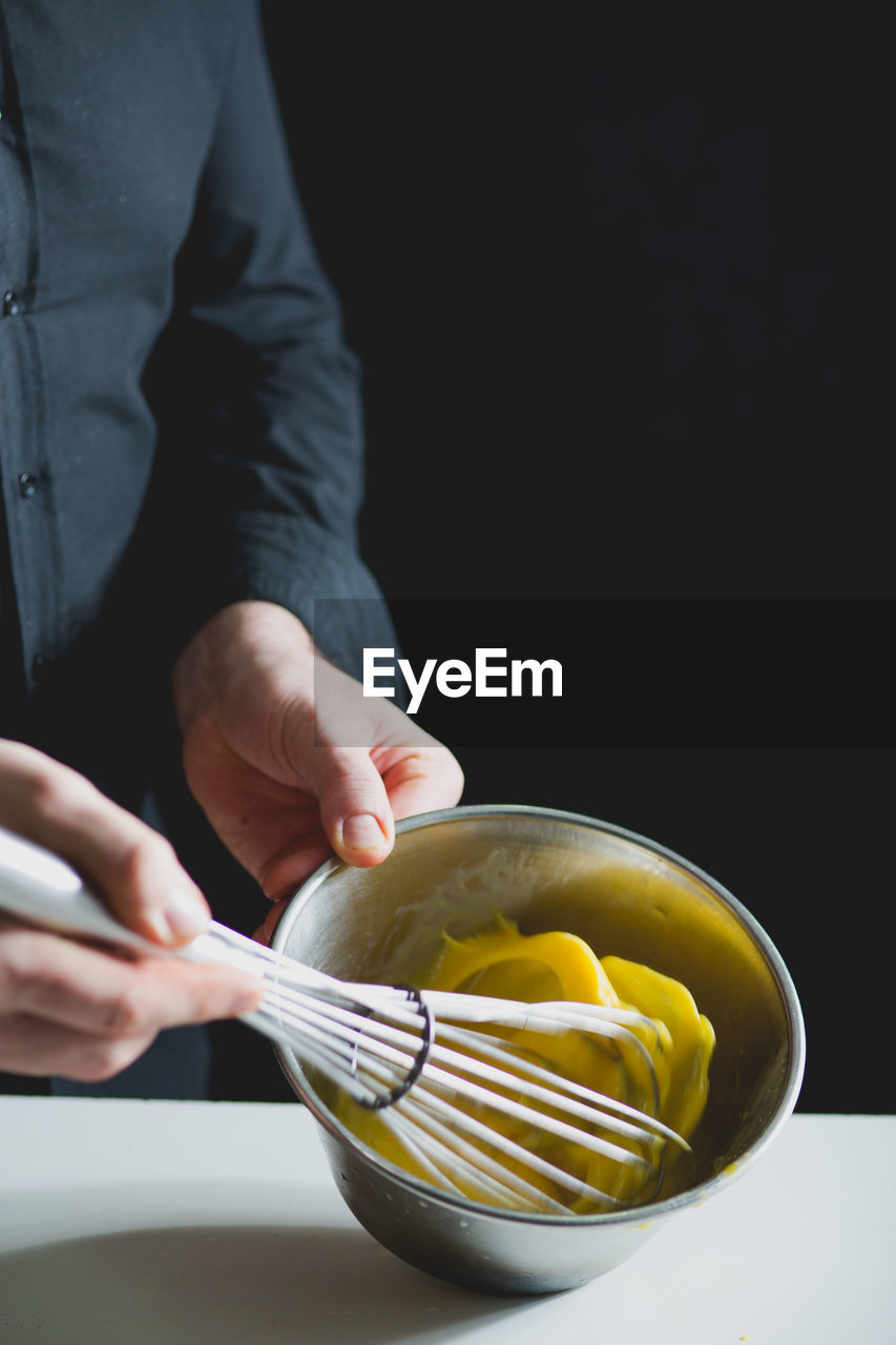 Close-up view of chef whisking egg