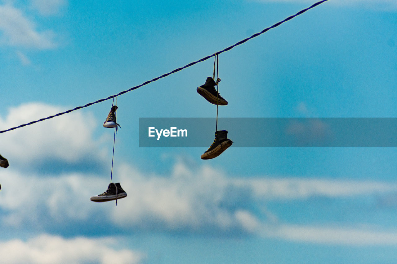 Low angle view of shoes on cable