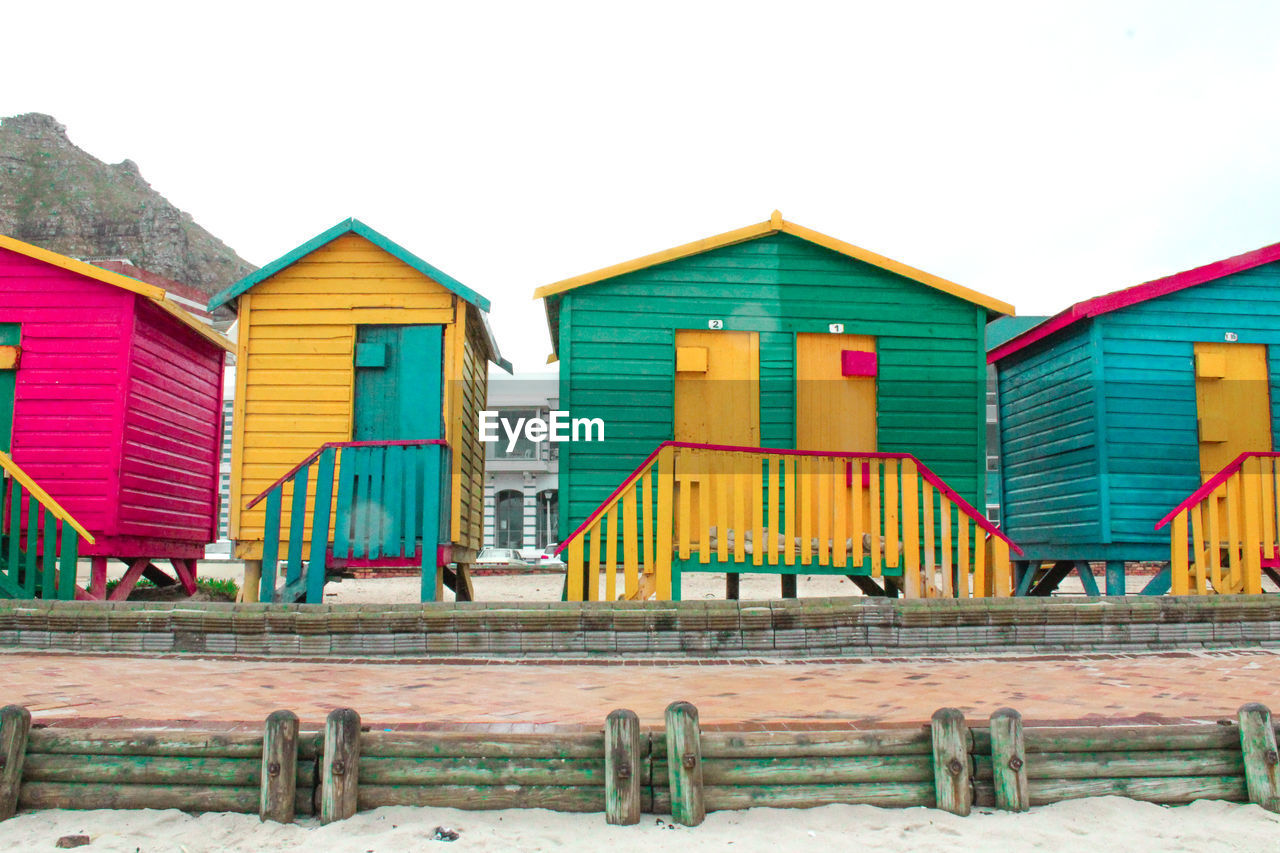 BEACH HUTS AGAINST SKY