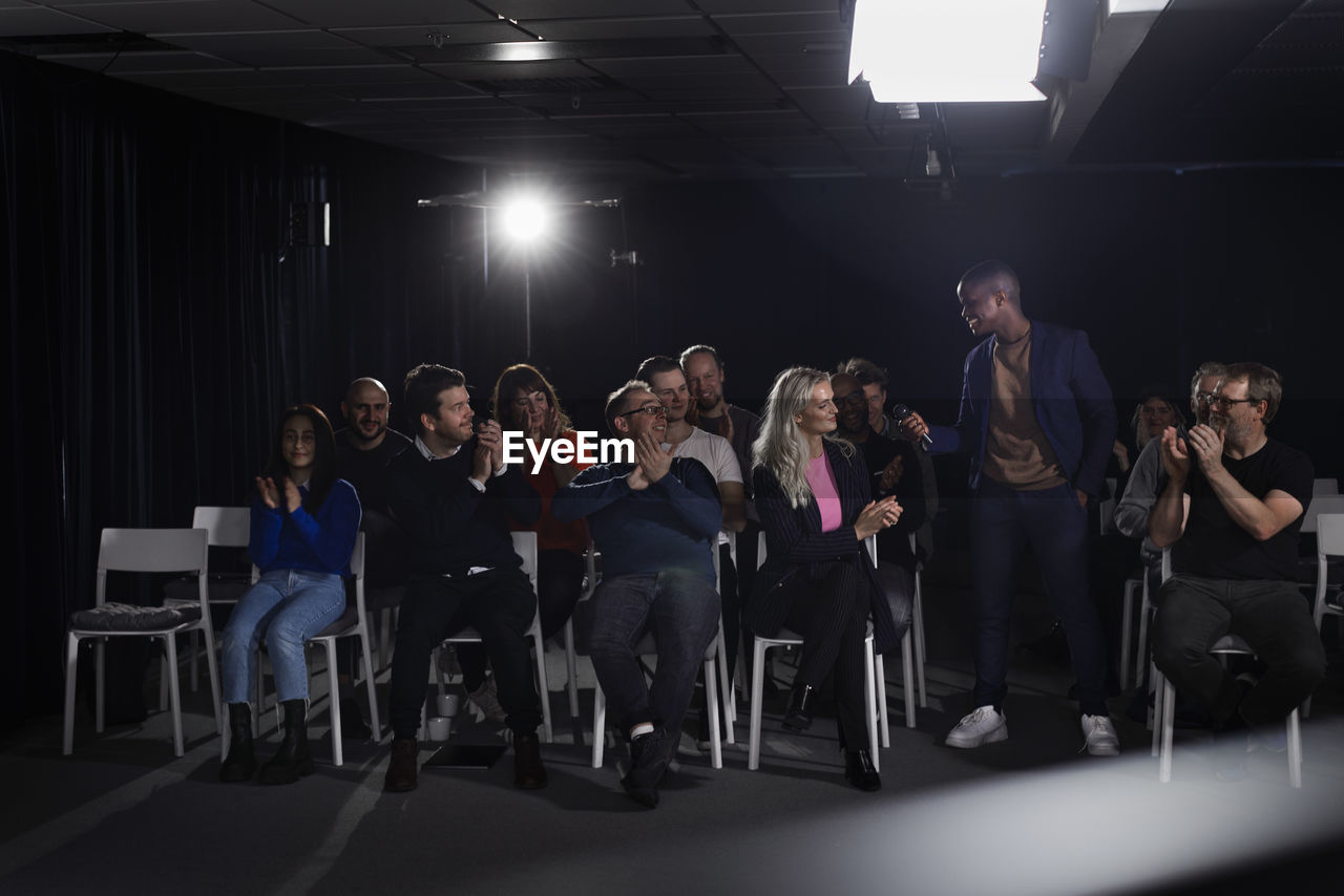 Tv show host interviewing audience member