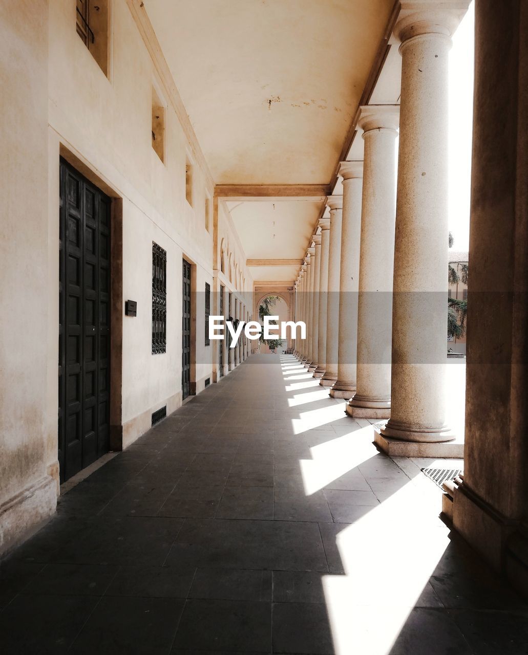 EMPTY CORRIDOR ALONG BUILDINGS