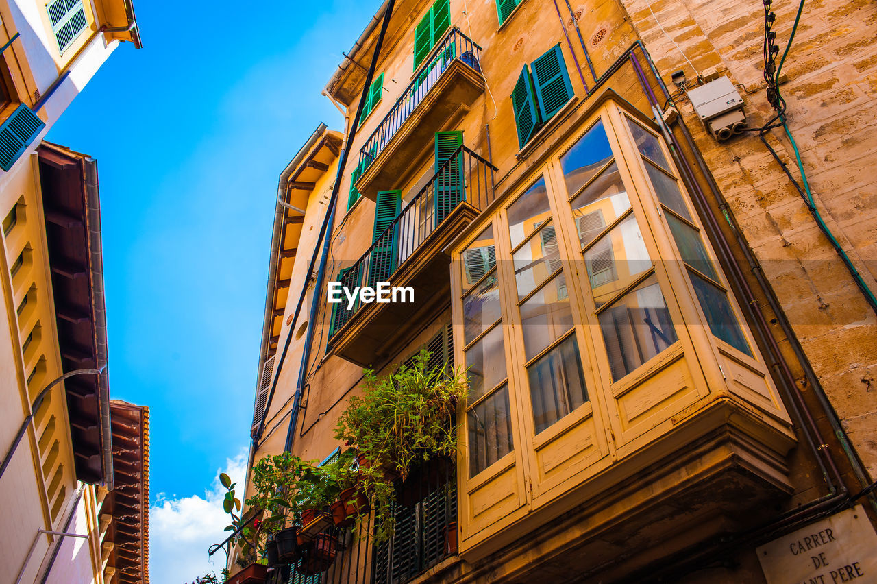 Low angle view of buildings against blue sky