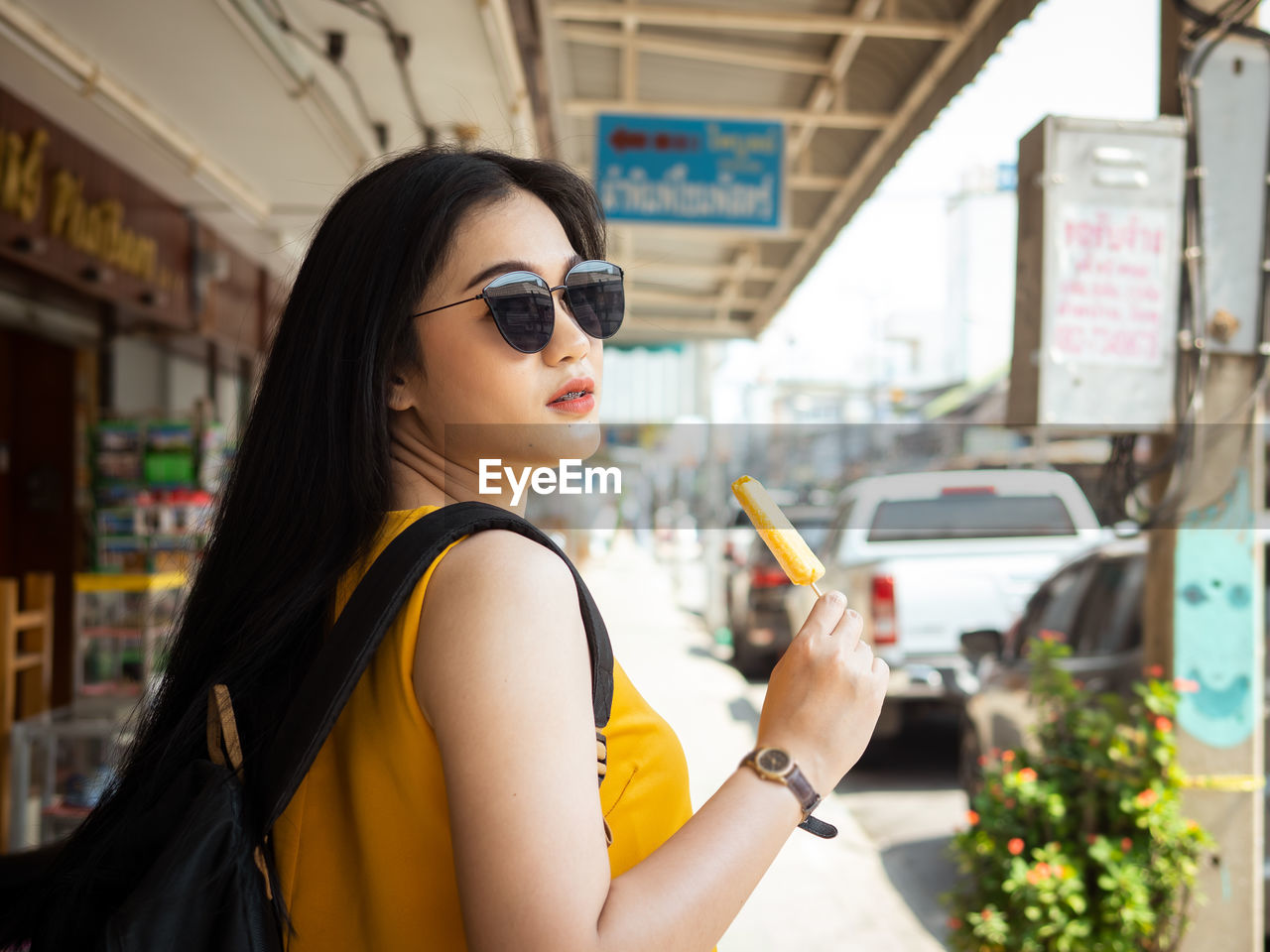 PORTRAIT OF A YOUNG WOMAN IN SUNGLASSES