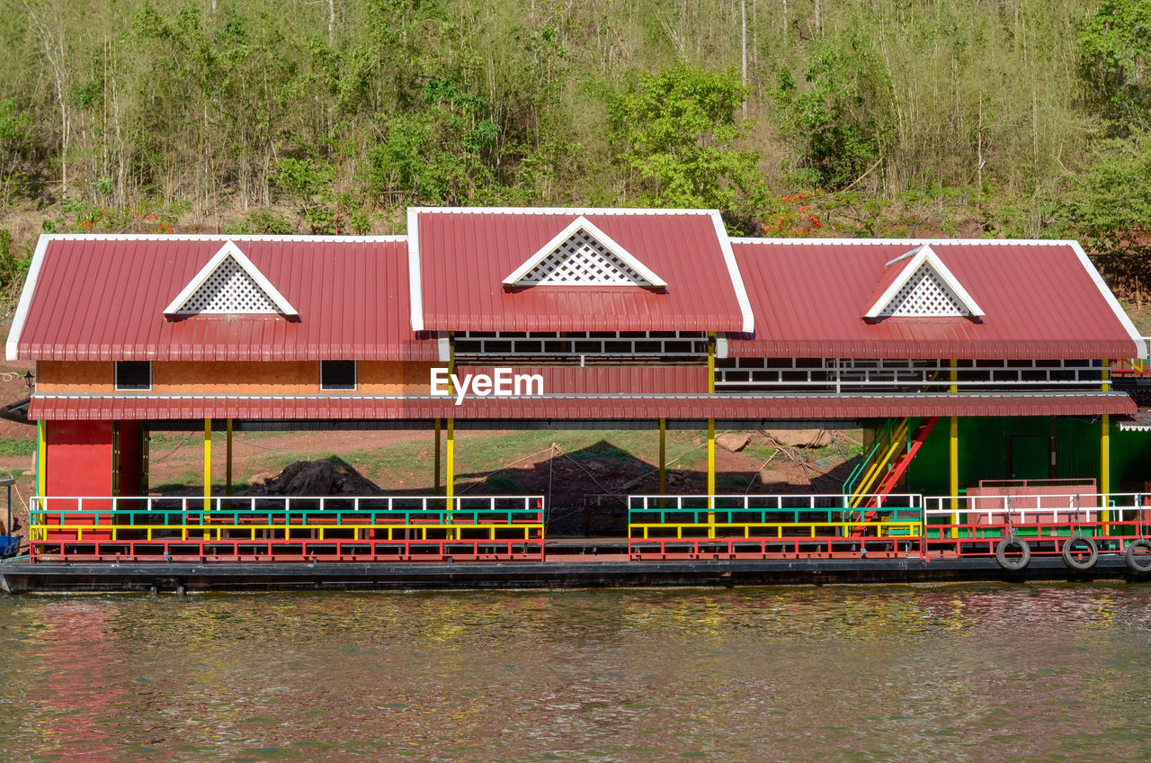 House by river against building