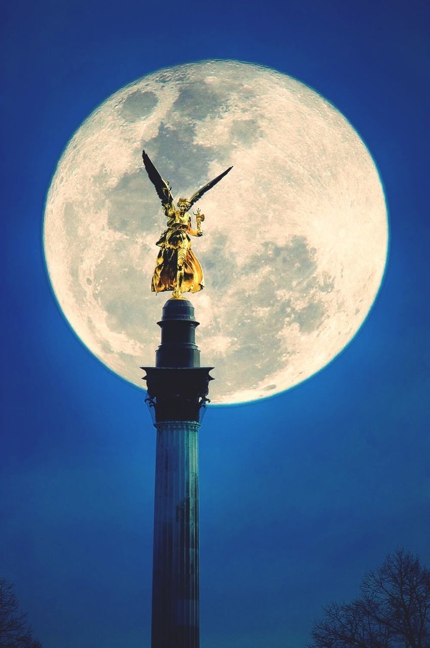 Friedensengel statue against majestic full moon