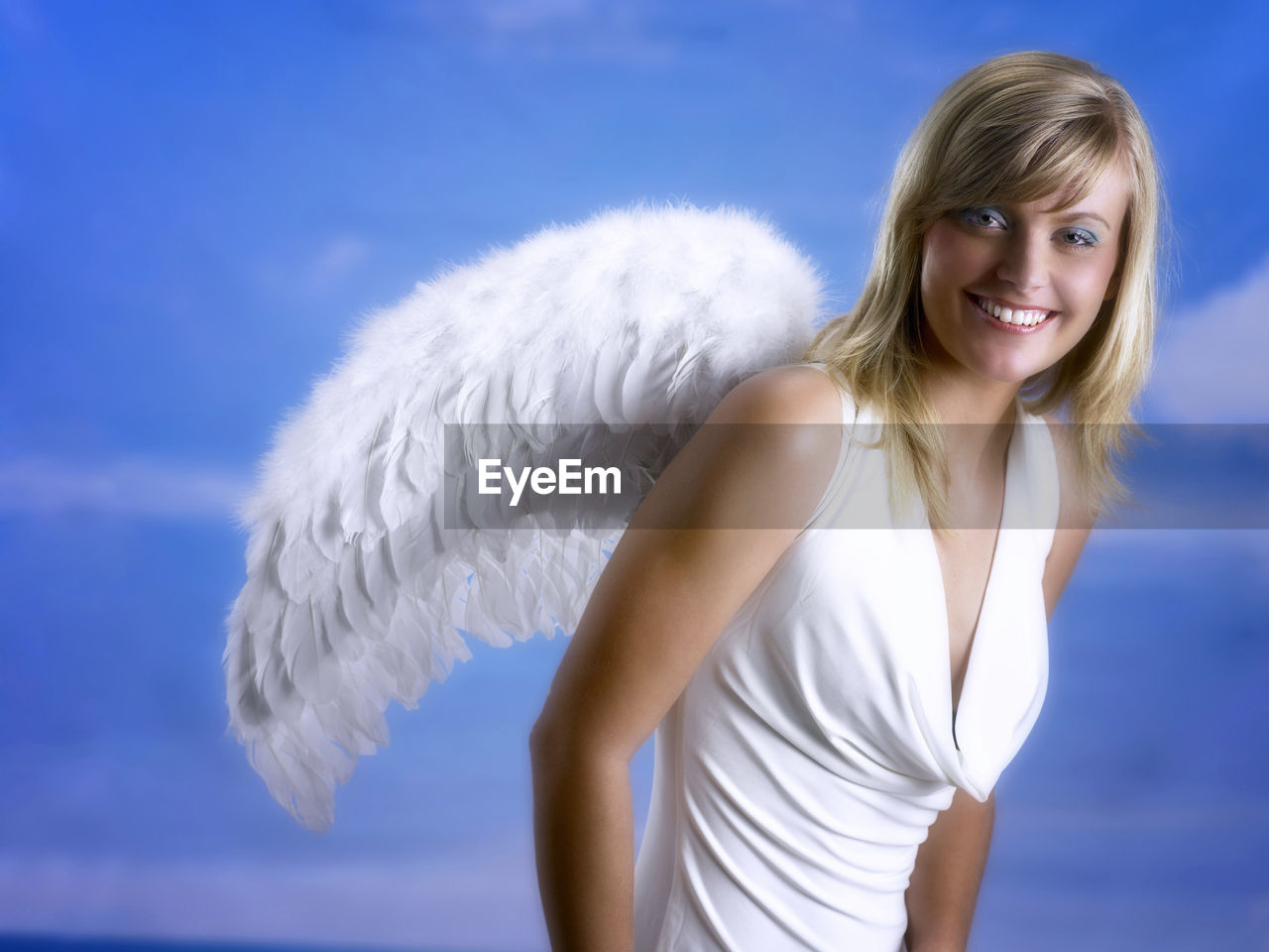 Portrait of beautiful young woman wearing angel wings