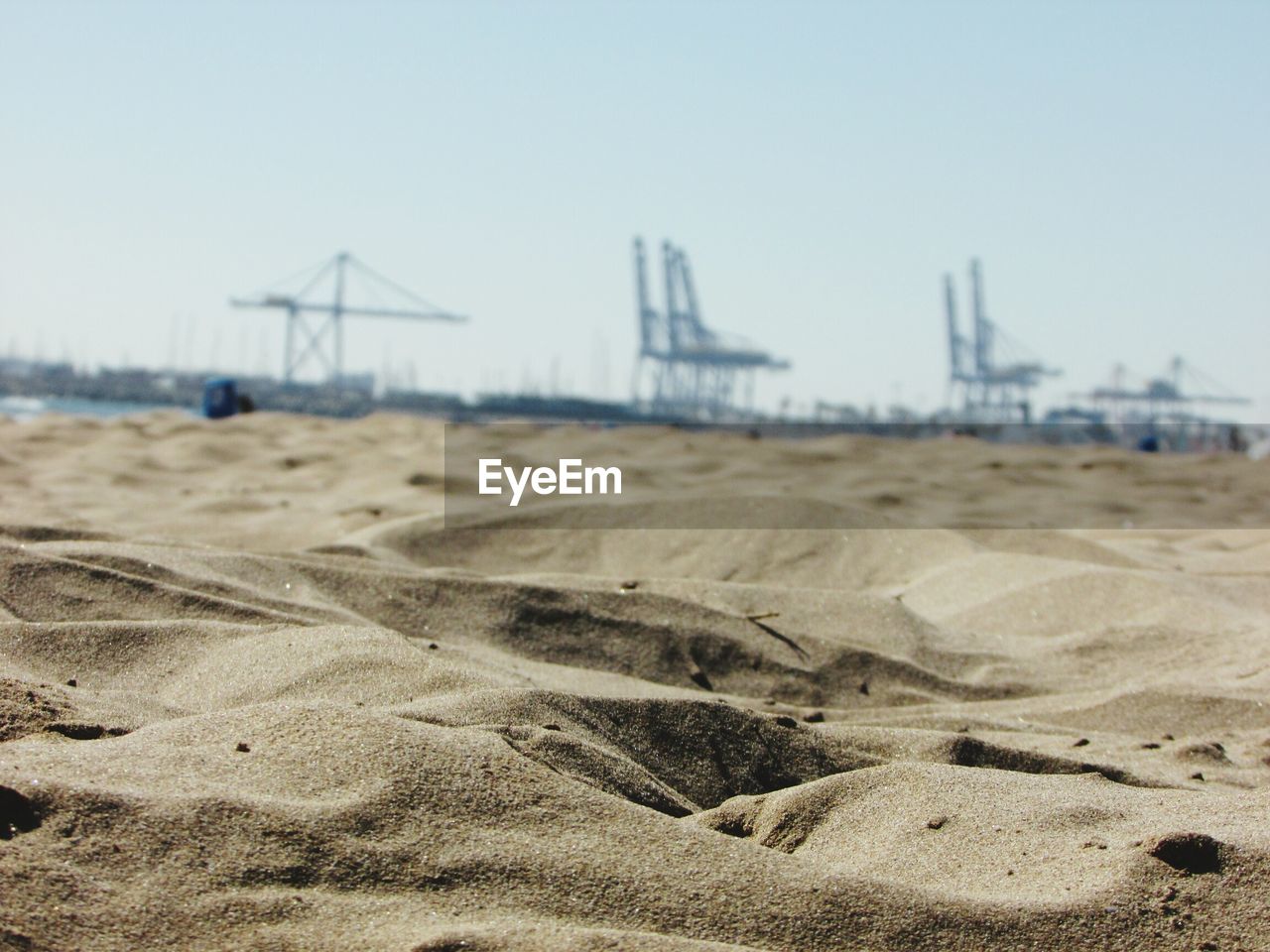 CLOSE-UP OF SAND AGAINST CLEAR SKY