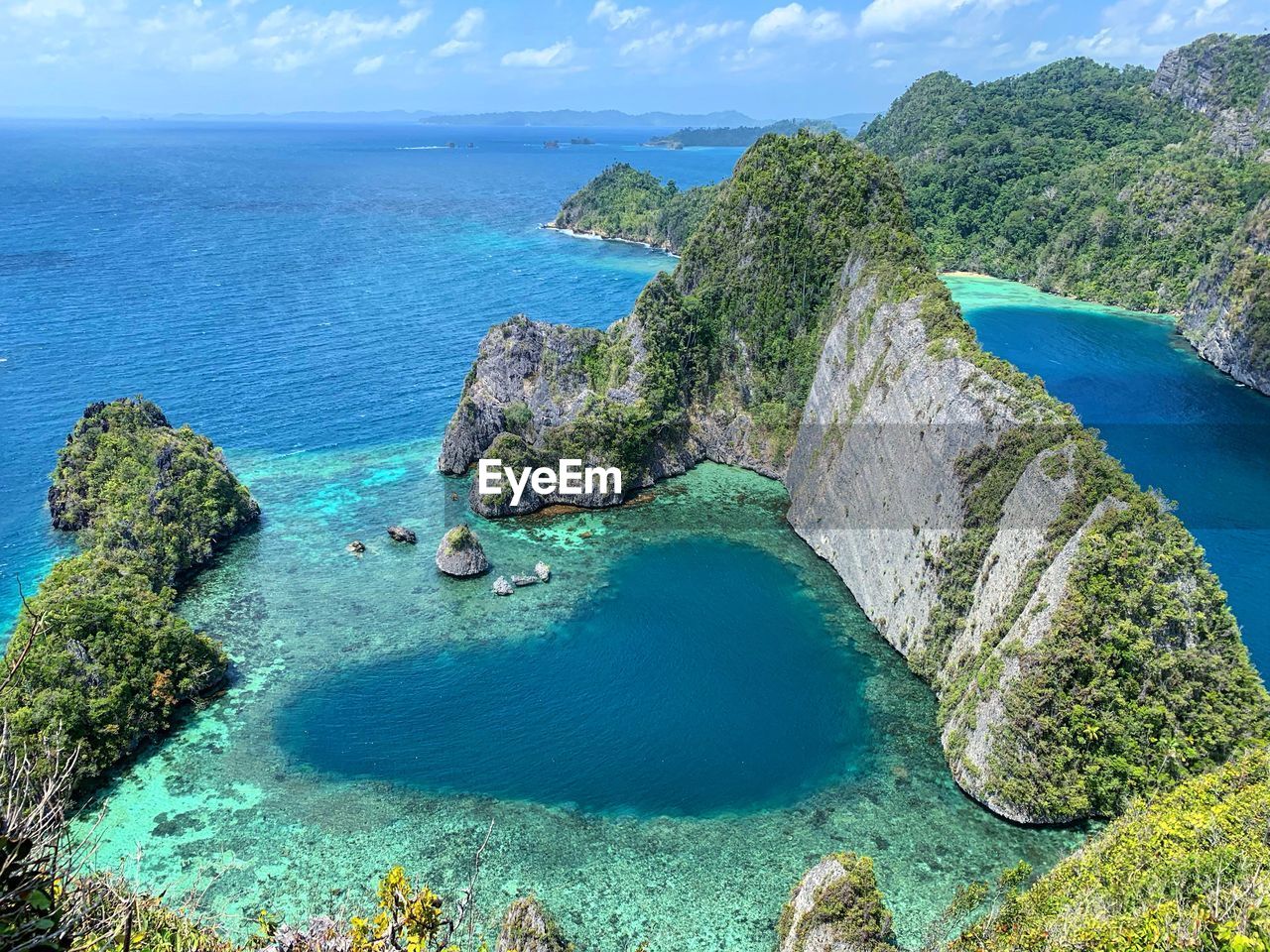 High angle view of rocks on sea shore against sky of love lagoon misool island raja ampat 