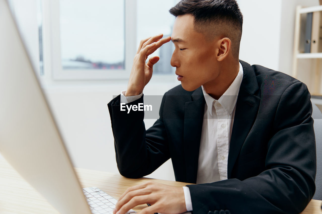 Businesswoman using laptop at office