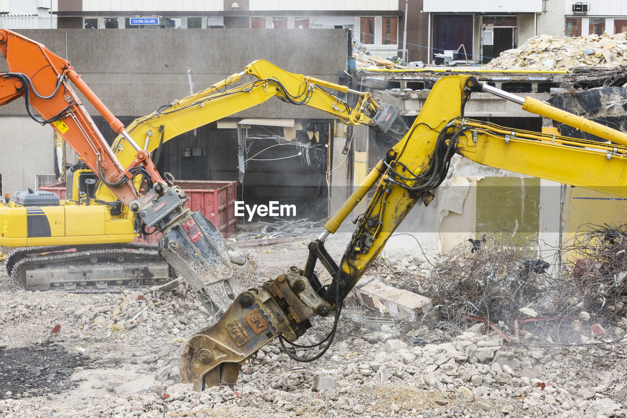 Diggers demolishing buildings