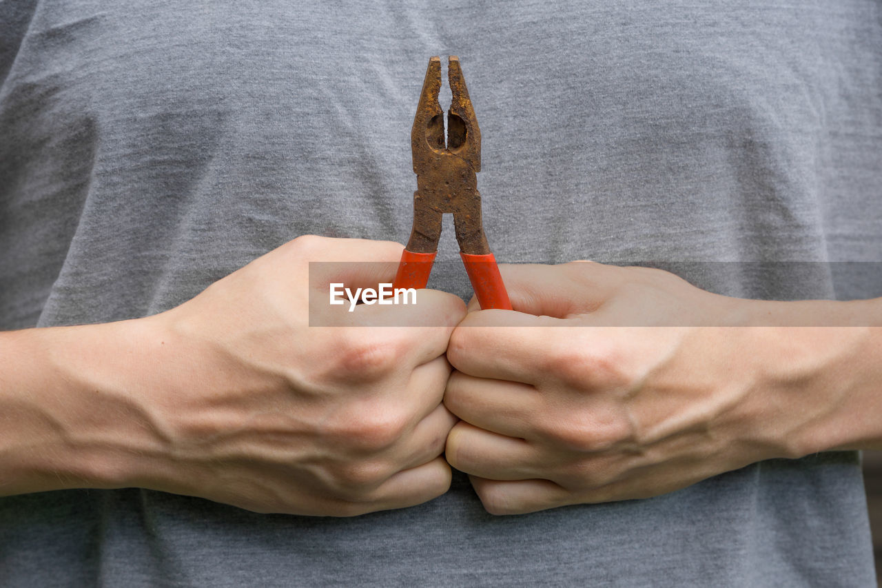 midsection of man holding key ring