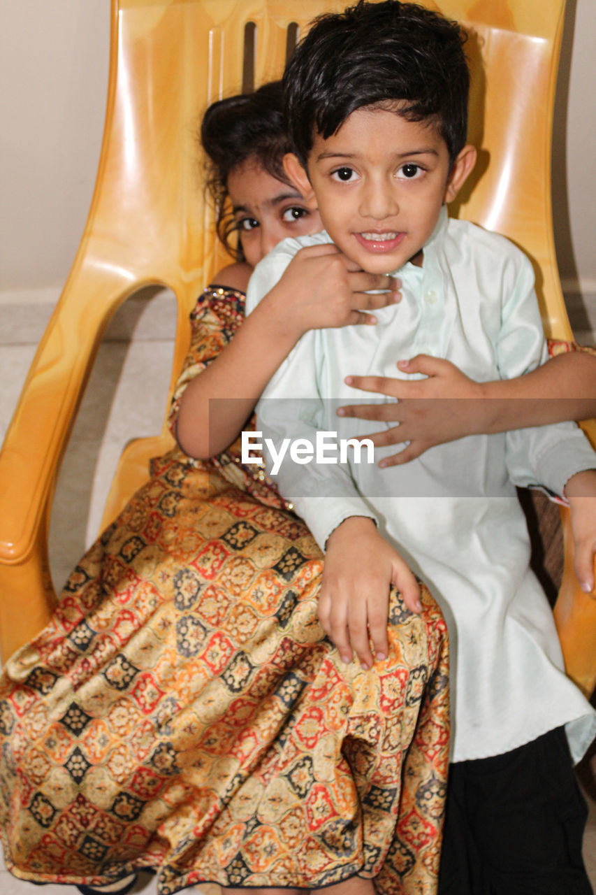 PORTRAIT OF A SMILING BOY WITH HANDS