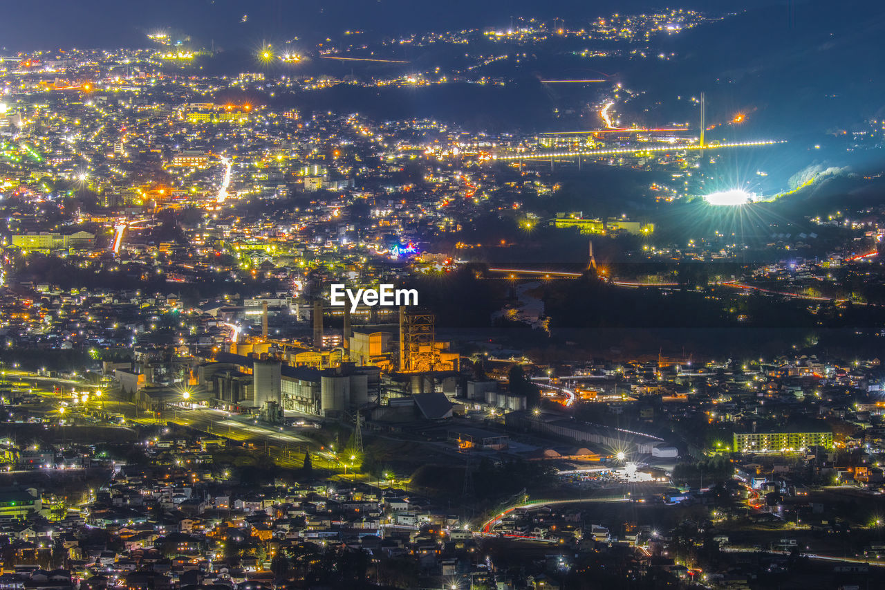 High angle view of illuminated buildings in city at night