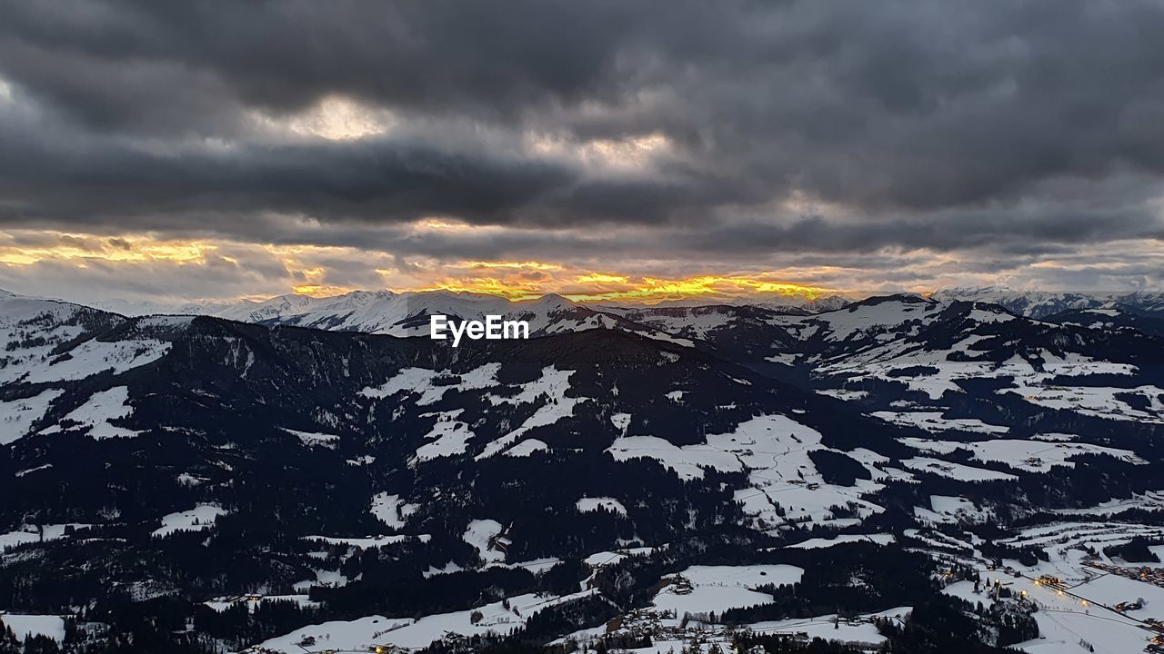 SCENIC VIEW OF SNOWCAPPED MOUNTAINS DURING SUNSET