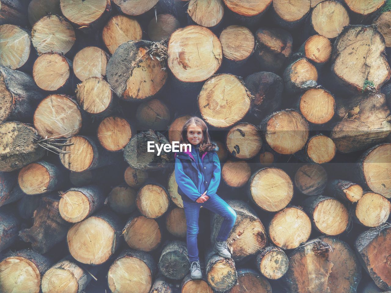 Portrait of girl standing no logs