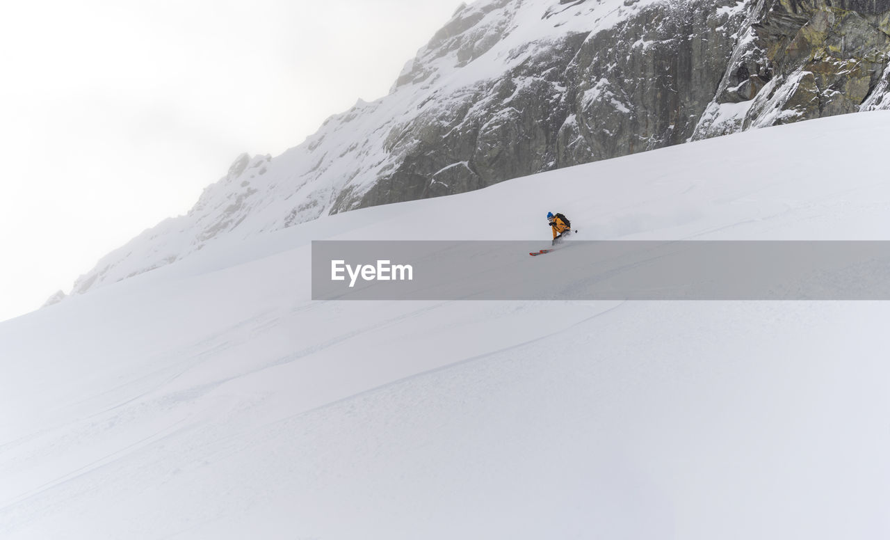 Person skiing on snowcapped mountain