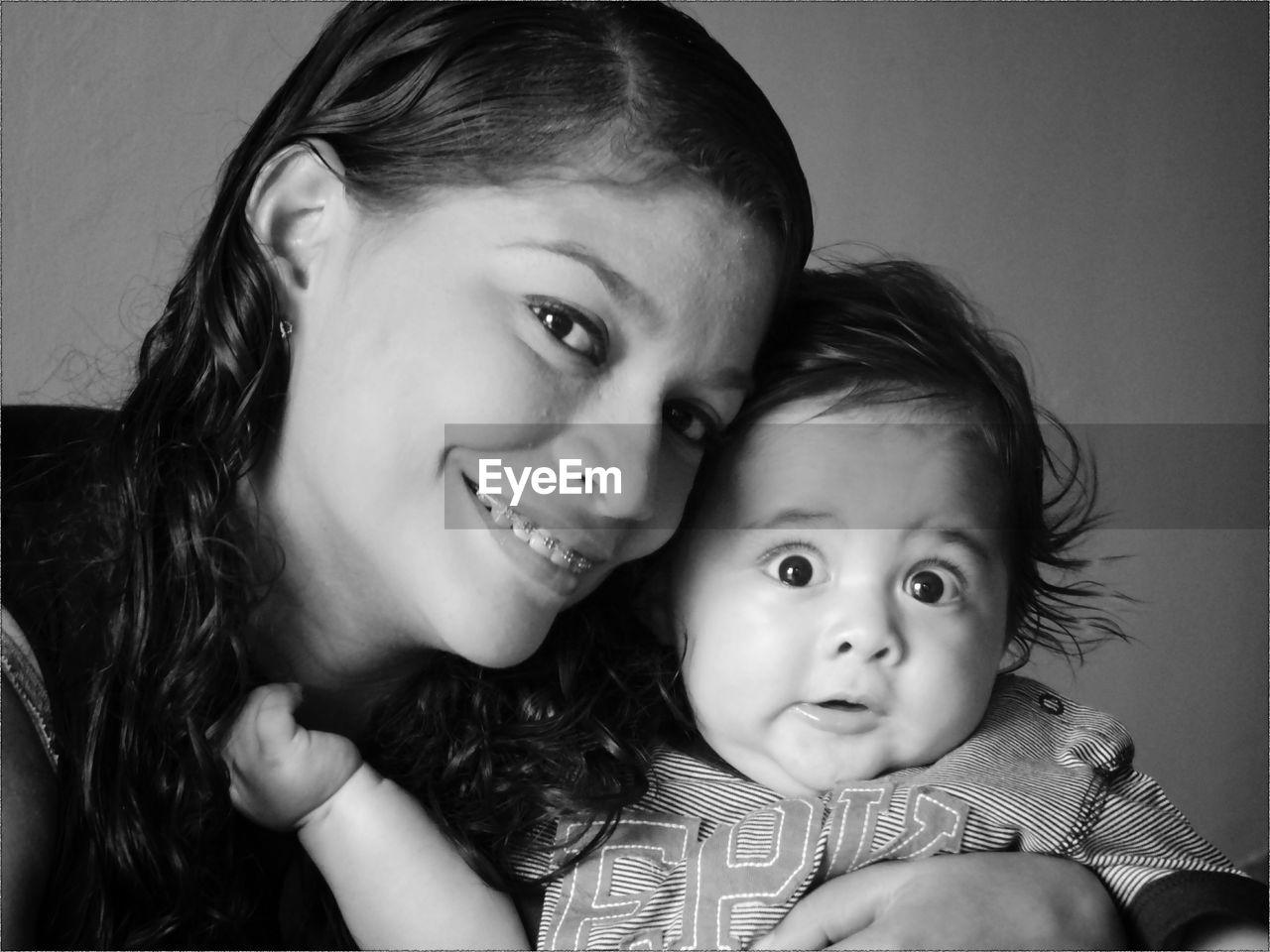 Portrait of happy mother with son at home