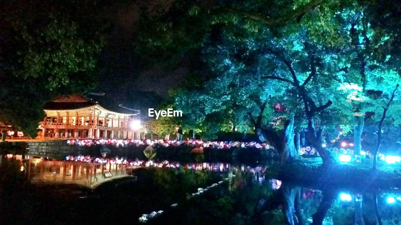 REFLECTION OF ILLUMINATED BUILDING IN WATER