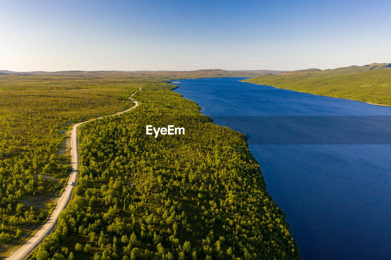 Aerial view of pulmankijärvi lake and sand banks surrounded by forest in nuorgam, finnish lapland