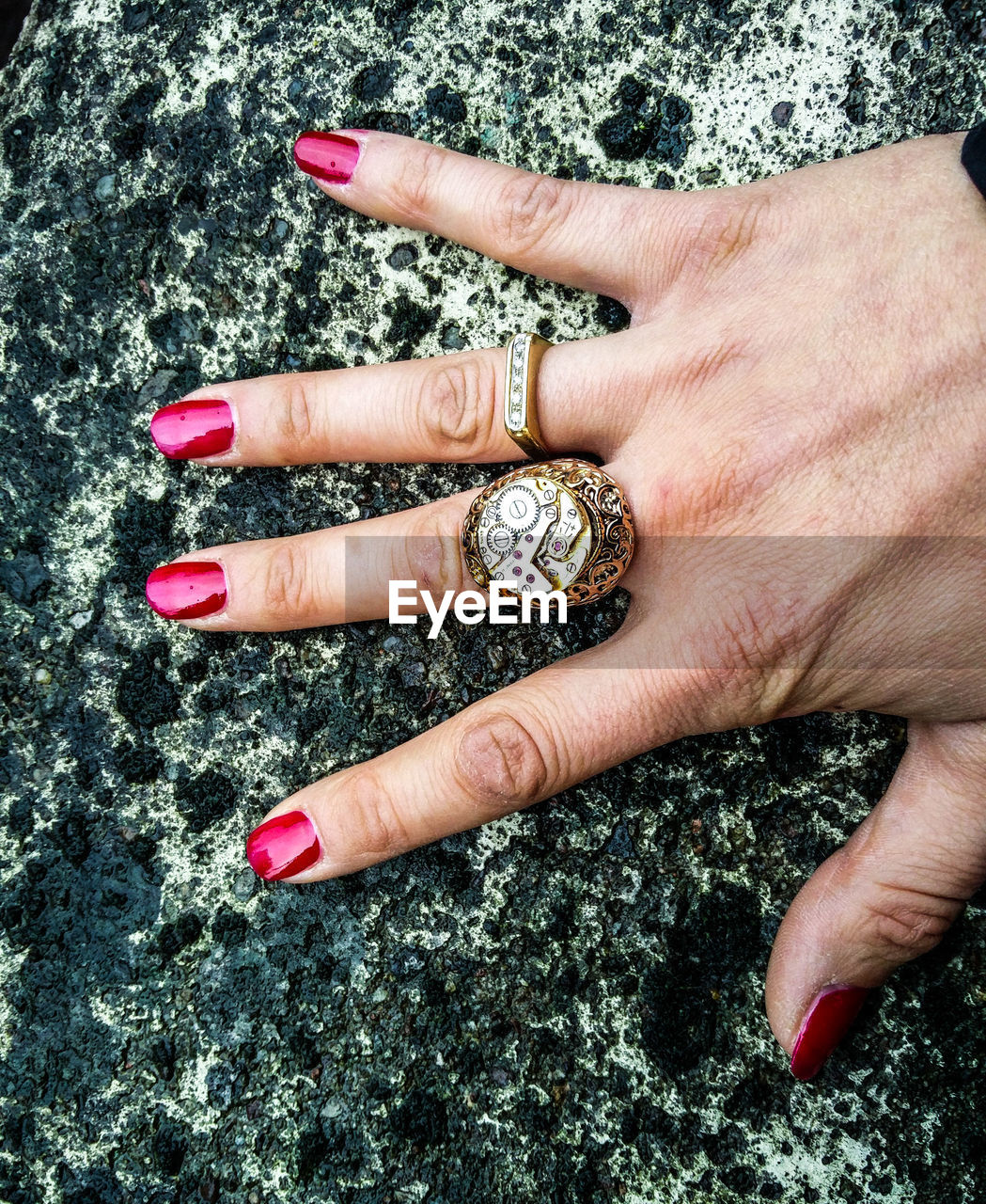 Cropped hand of woman with rings on rock