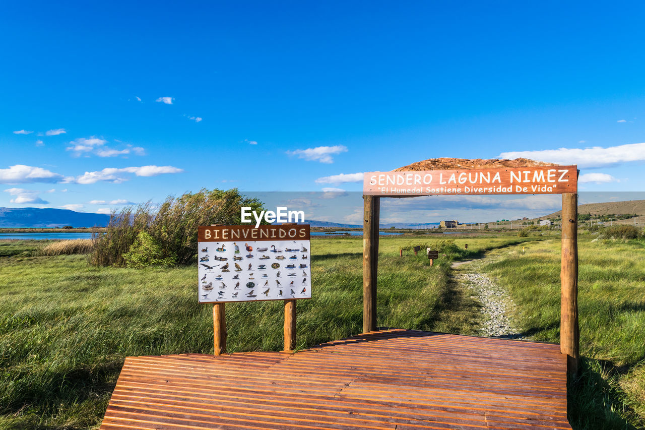 SIGN ON FIELD AGAINST SKY