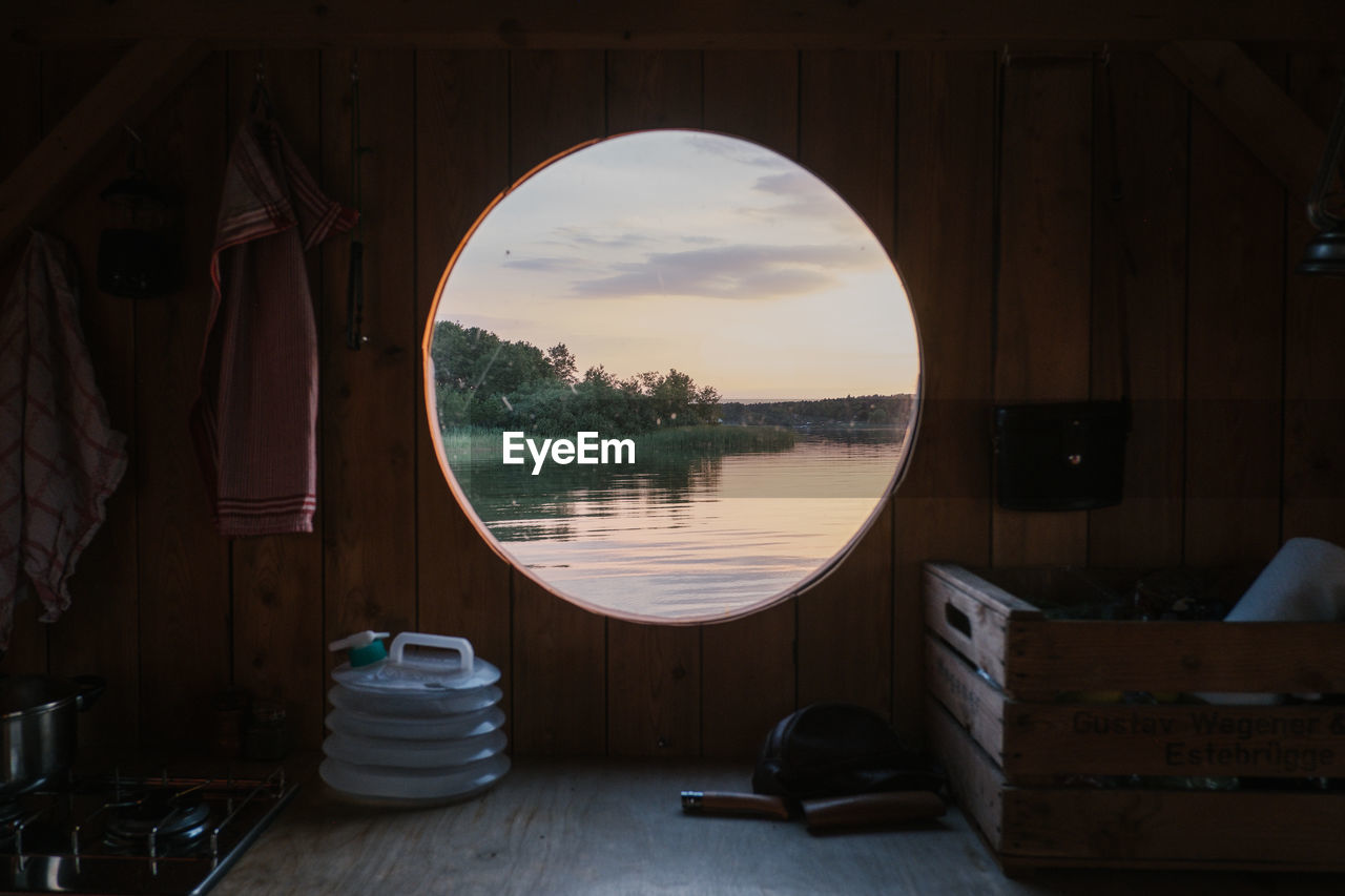 Scenic view of lake seen through boat during sunset