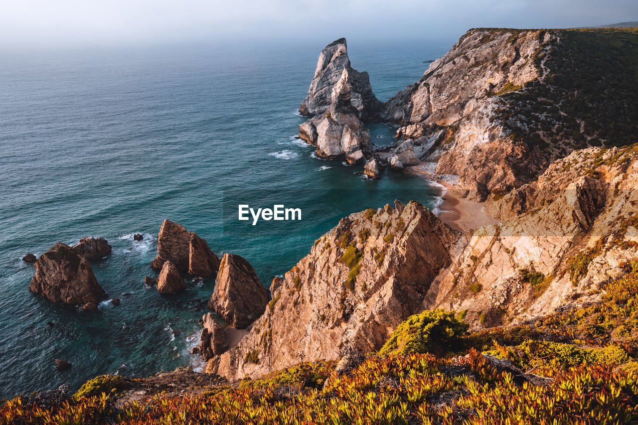 High angle view of rocks on sea shore