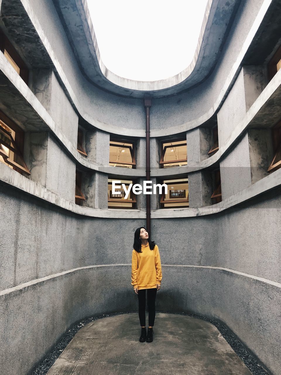 Full length of woman standing on floor of building