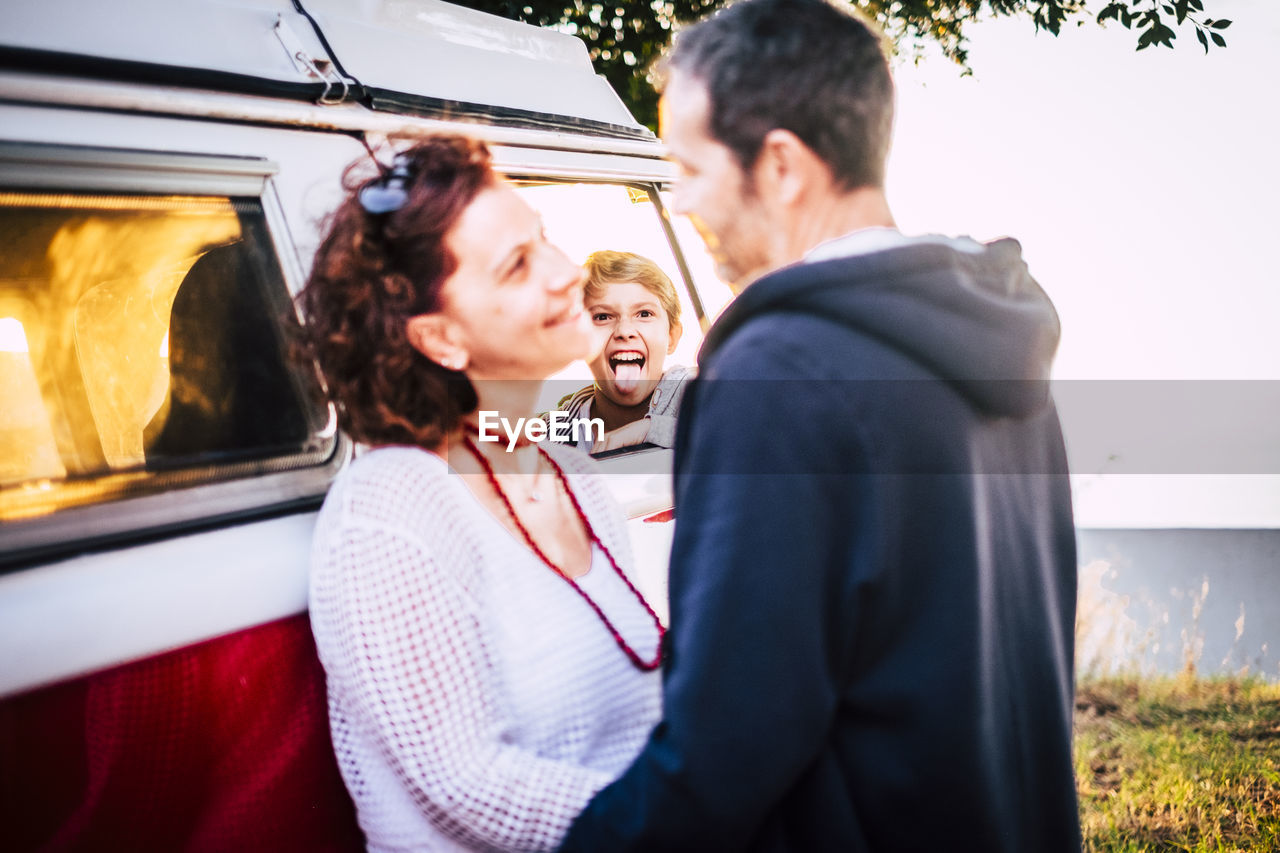 Cute son looking at parents outdoors