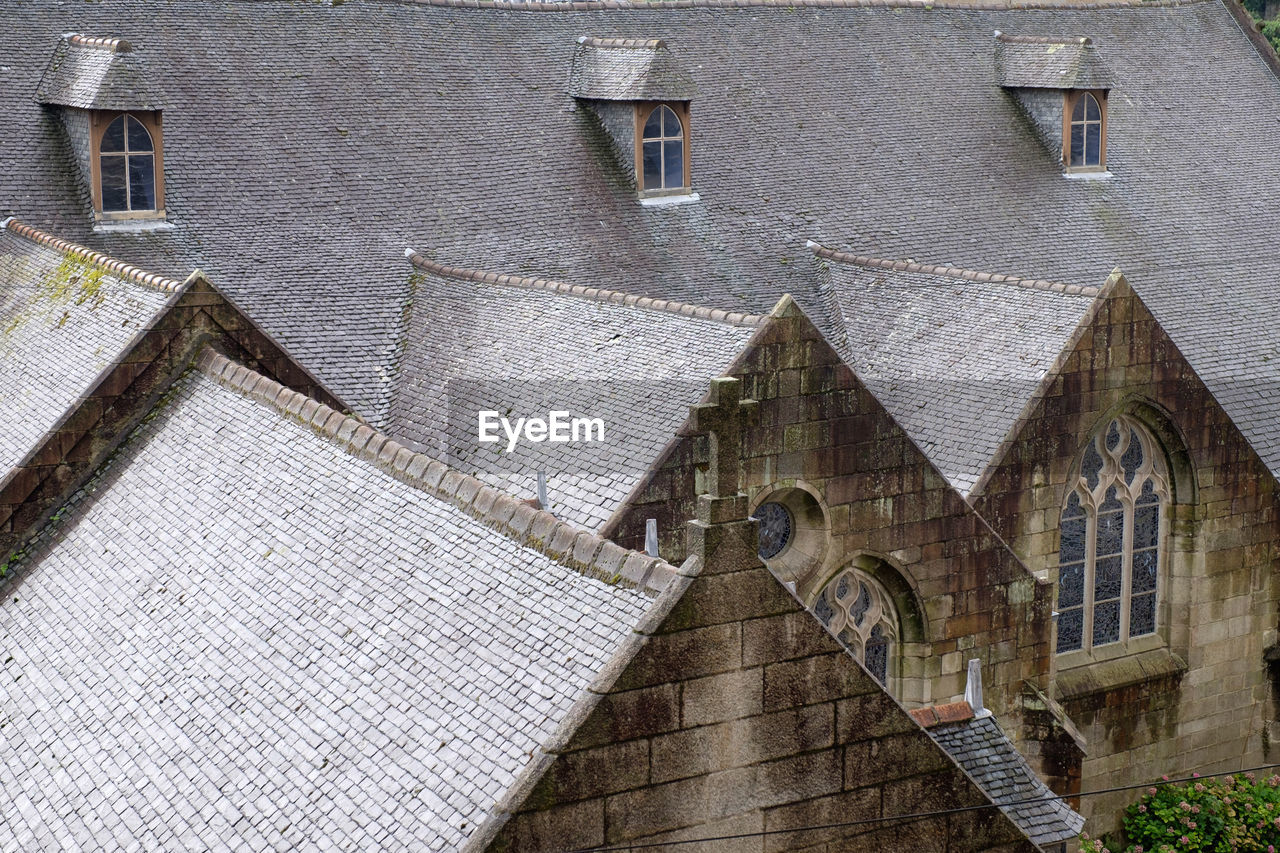 LOW ANGLE VIEW OF OLD BUILDING BY HOUSE