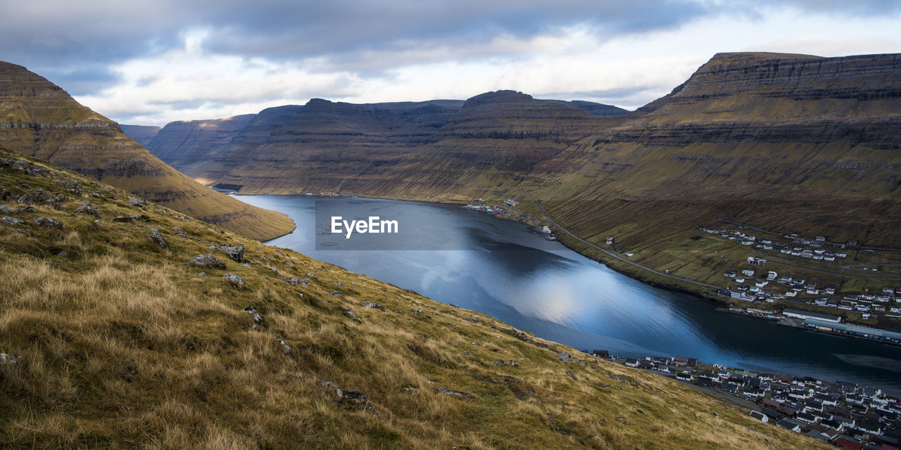 Scenic view of lake and mountains against sky