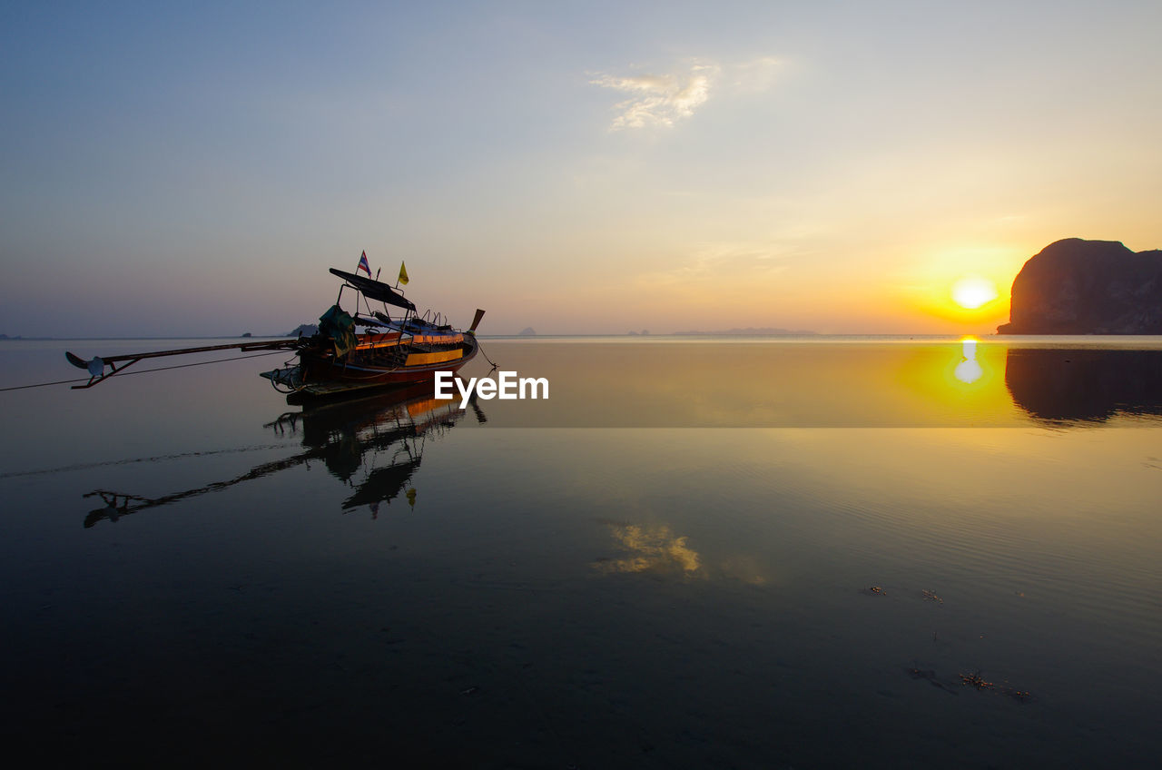 VIEW OF FISHING BOAT IN SEA DURING SUNSET