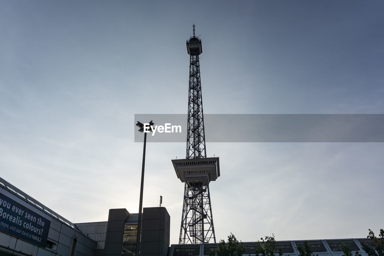 Low angle view of communications tower against sky