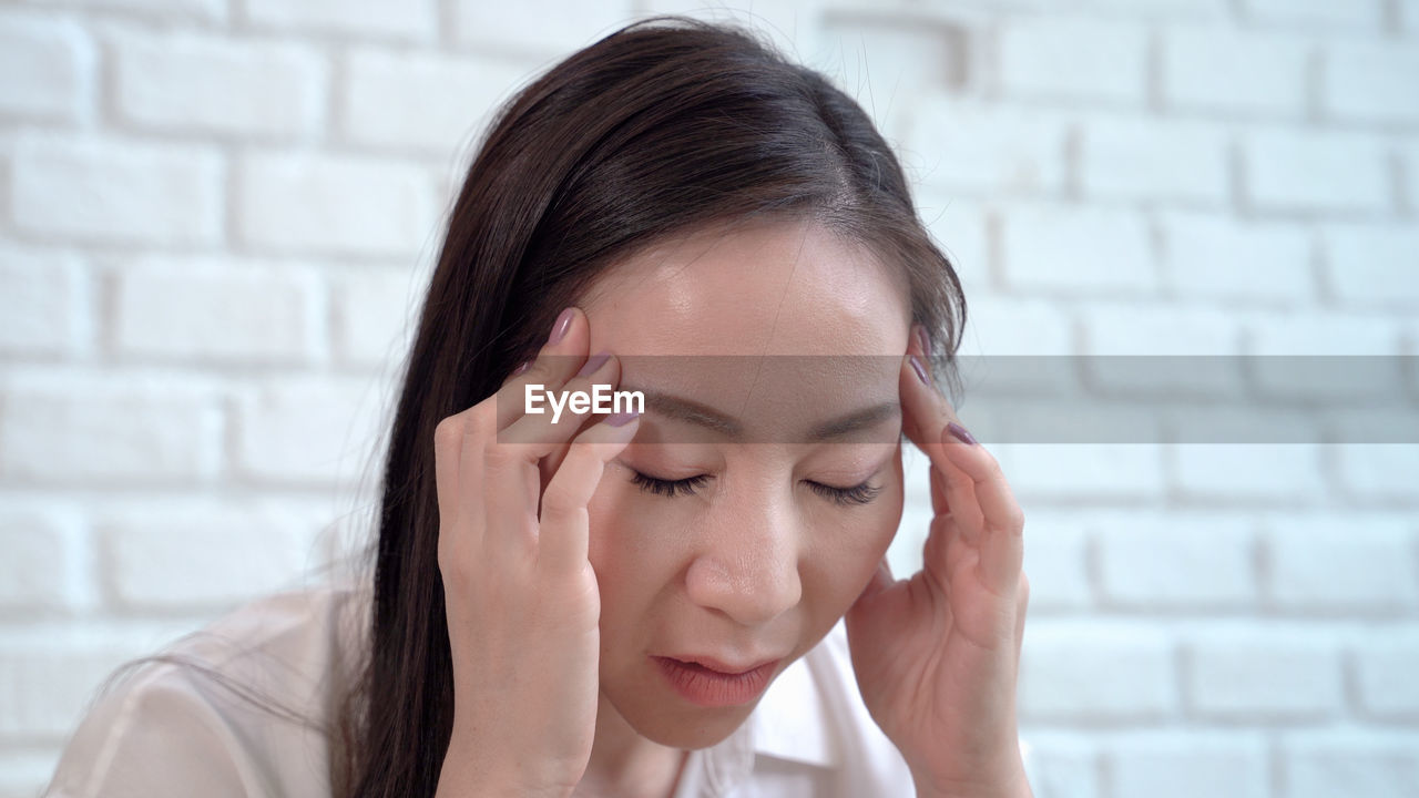 Close-up of woman suffering from headache