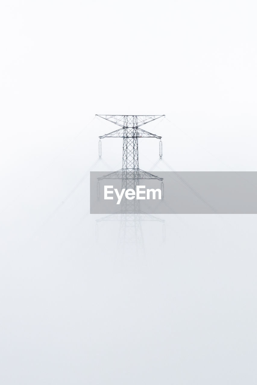 Electricity pylon against clear sky