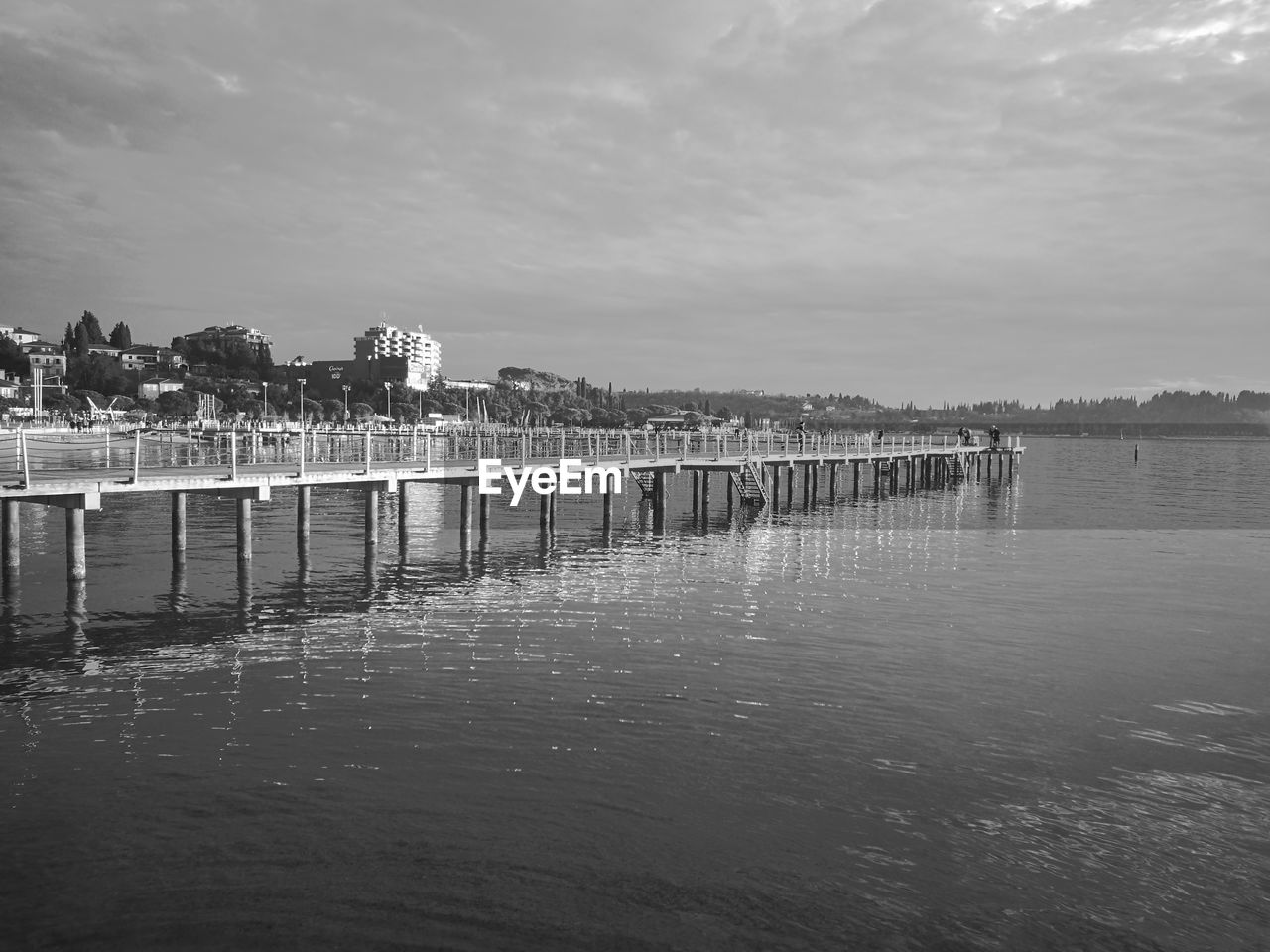 Wooden posts on the sea against sky