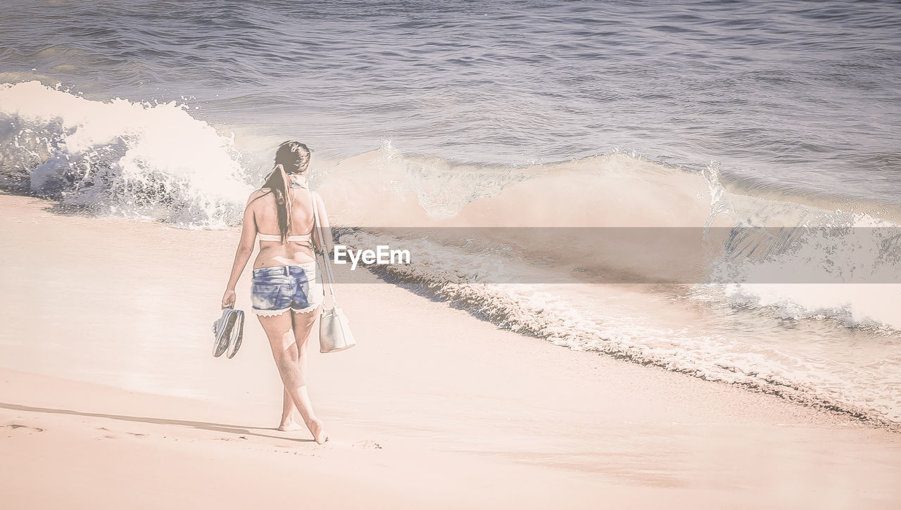 REAR VIEW OF BOY ON BEACH