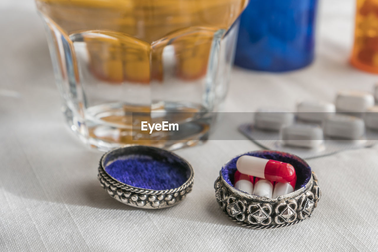 CLOSE-UP OF GLASSES ON GLASS TABLE