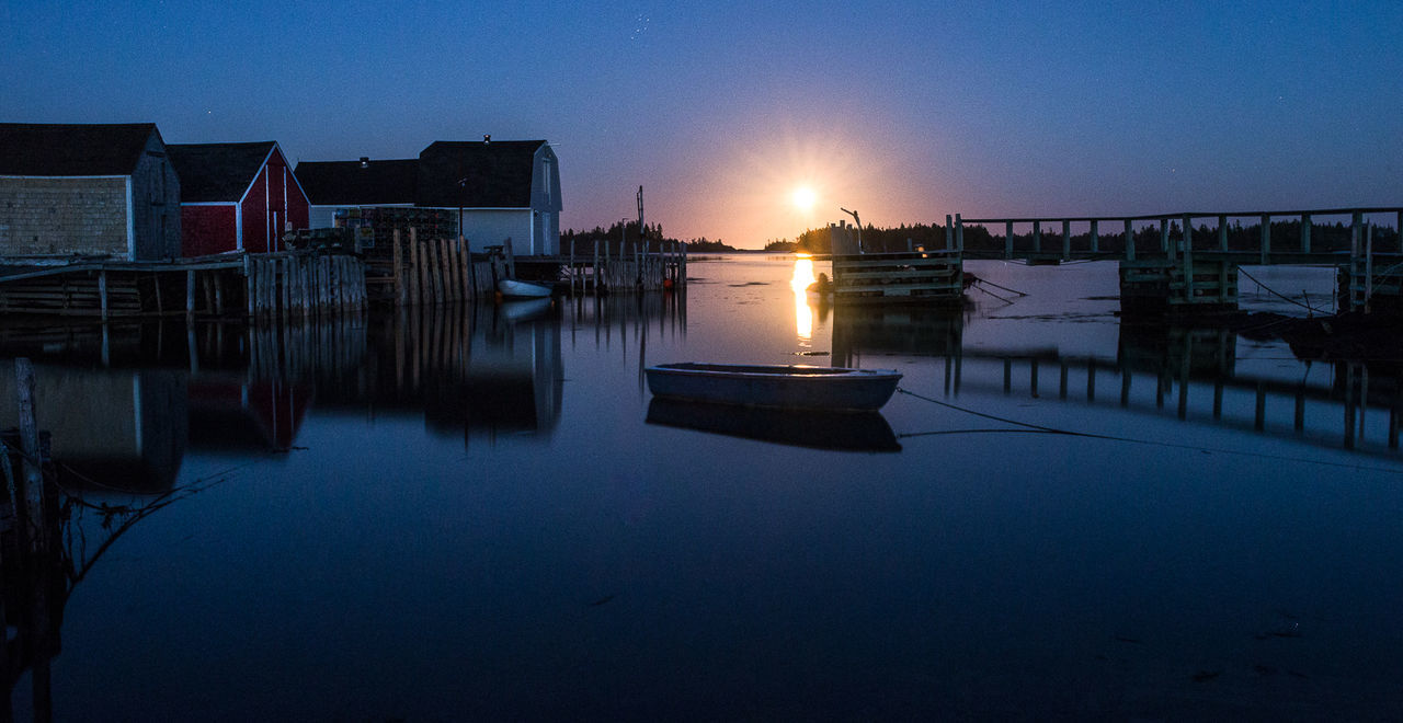 View of boats in sea at sunset