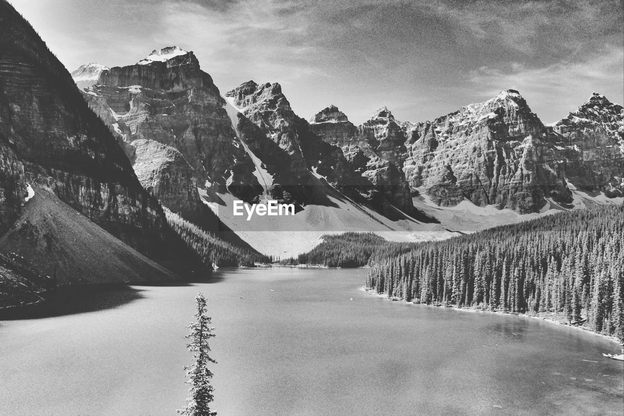 Frozen river passing through mountain range