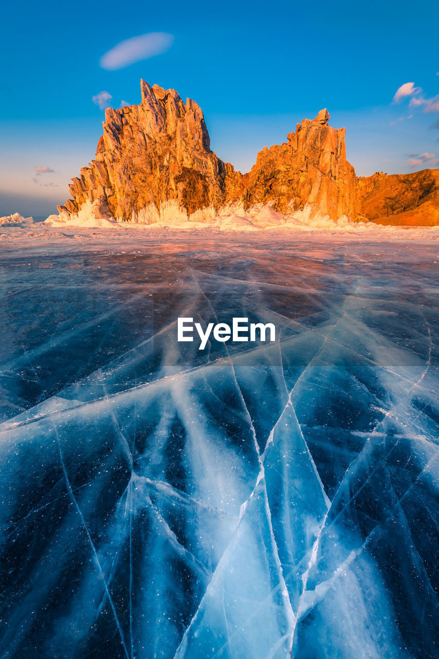 Scenic view of frozen lake against rock formation