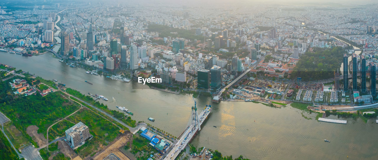 HIGH ANGLE VIEW OF RIVER AMIDST BUILDINGS