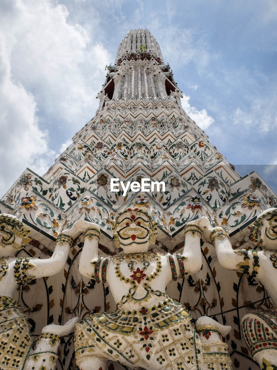 Low angle view of statue at temple against cloudy sky